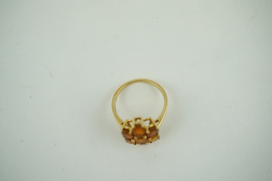 A 10K yellow gold orange stone cluster dress ring, size N, gross weight 2.6 grams. Condition - fair